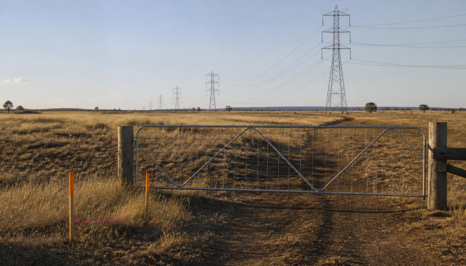 A hand signing a legal document, illustrating a landowner considering a data centre developer's option deed